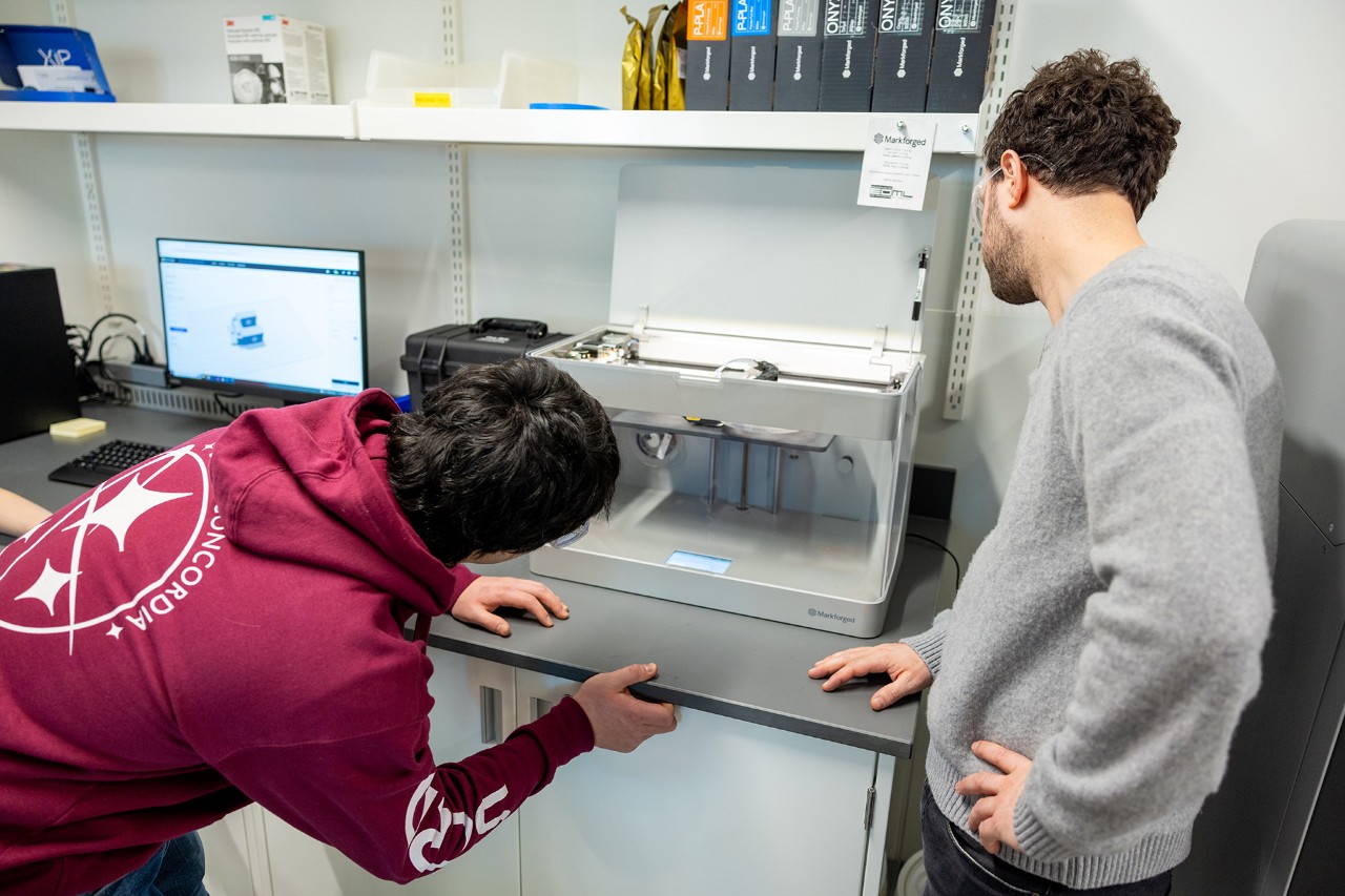 Students using a 3D printer in the Gina Cody School Makerspace lab.