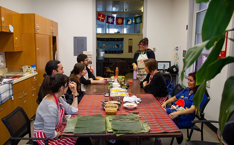 A group of people sitting around a dining room table.