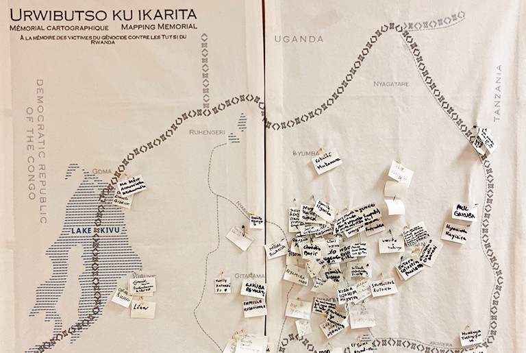 View of the cartographic memorial with contributions from members of the Montreal Rwandan Community on April 27, 2024. A sepia map with words stuck onto it.